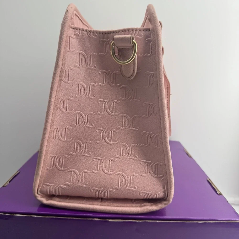 Y2K Juicy Couture satchel in pink, features an all-over embossed 